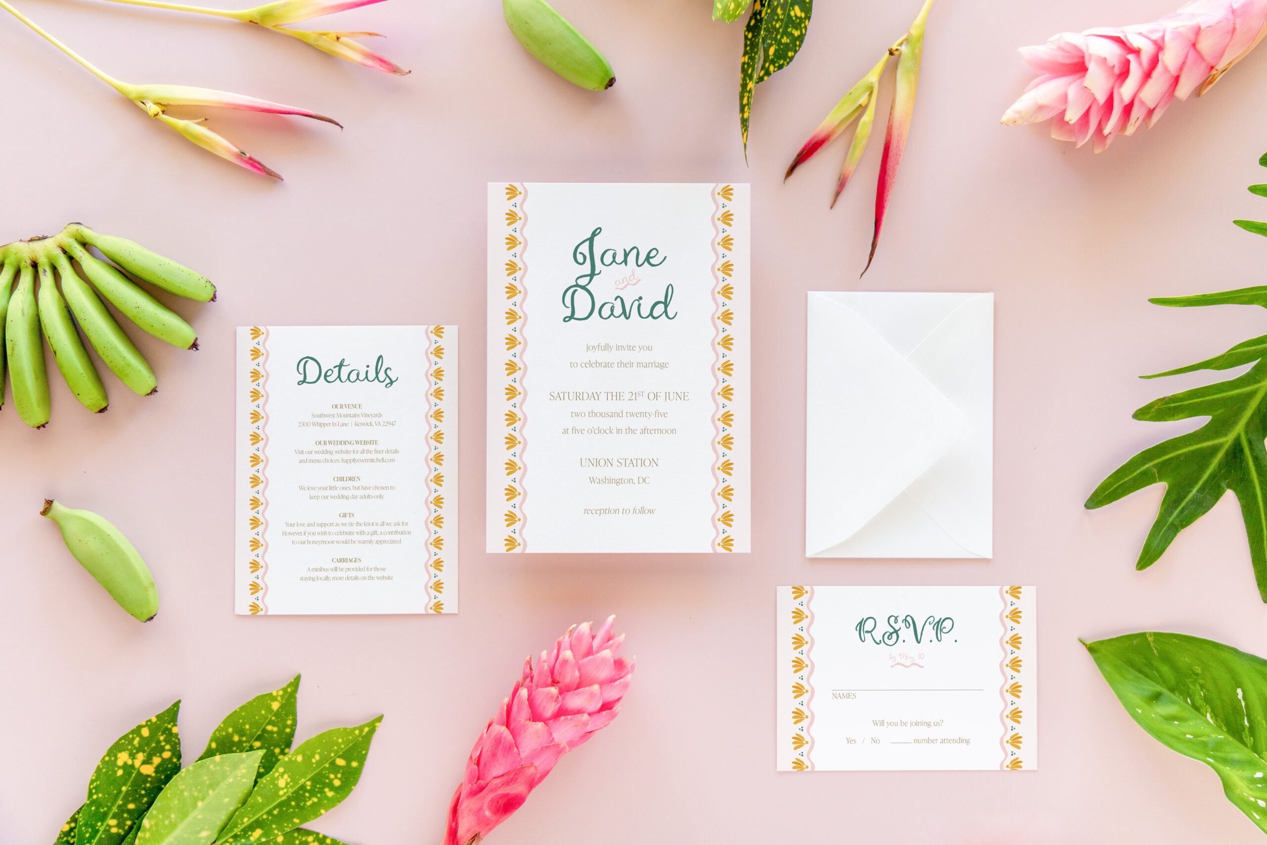 Flat lay of luxury wedding invitation suite with five pieces — invitation, RSVP card, details card, lined envelope, and RSVP envelope — styled on a pink background with tropical decor accents. Perfect for elegant or destination weddings.